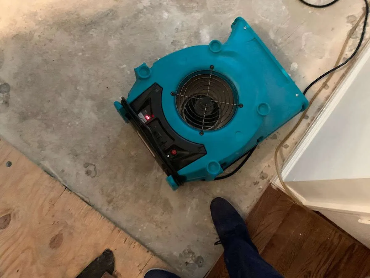 Air mover drying subfloor during Commercial Water Damage Restoration in Lander